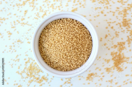 Wholegrain couscous in the bowl on the white background