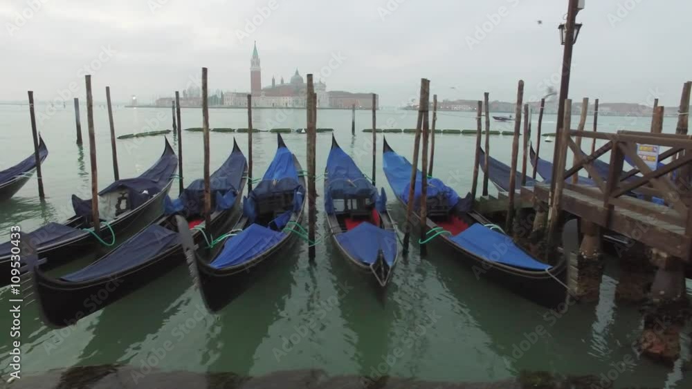 Gondolas swinging on the water near the pier in the foggy morning, Venice, Italy
Gondolas swinging on the water near the pier in the foggy morning, Venice, Italy