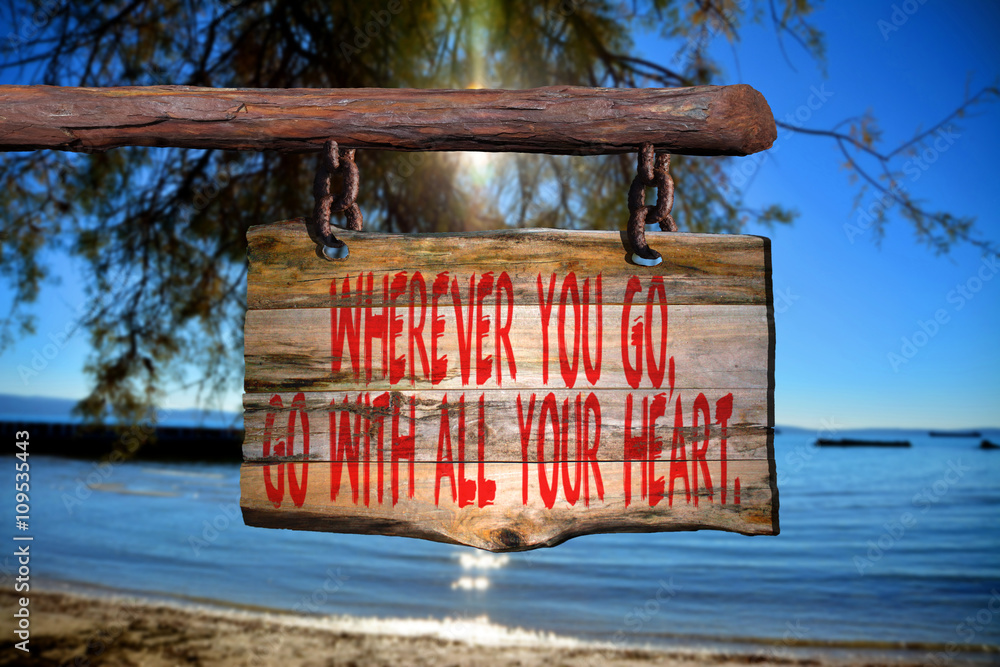 Fototapeta premium Wherever you go, go with all your heart motivational phrase sign