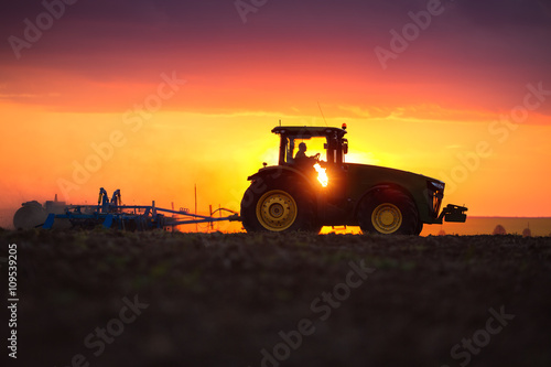 Farmer in tractor preparing land with seedbed cultivator © ValentinValkov