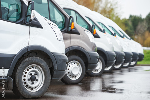 Canvas Print transporting service company. commercial delivery vans in row