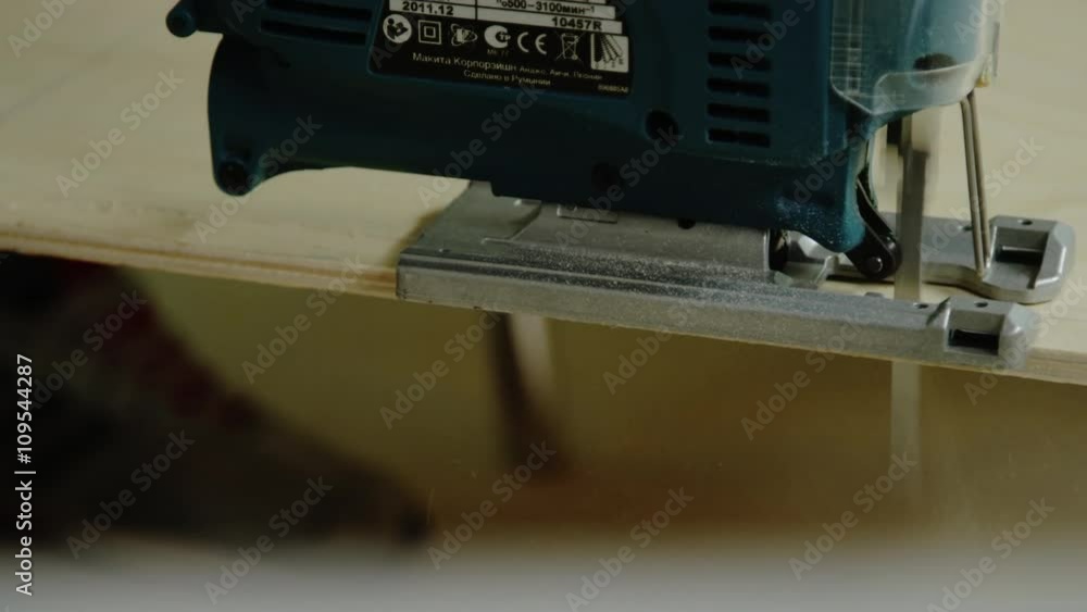 electric fretsaw cutting a plywood electric fretsaw cutting a plywood