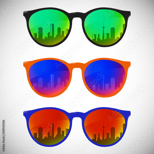 Trendy sunglasses with colorful lens and frame reflect city sky view in summer