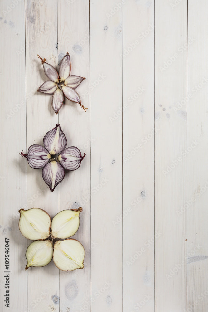 onion flat lay on a white wooden background. Spanish onion, shallot, red onion onion flat lay on a white wooden background. Spanish onion, shallot, red onion