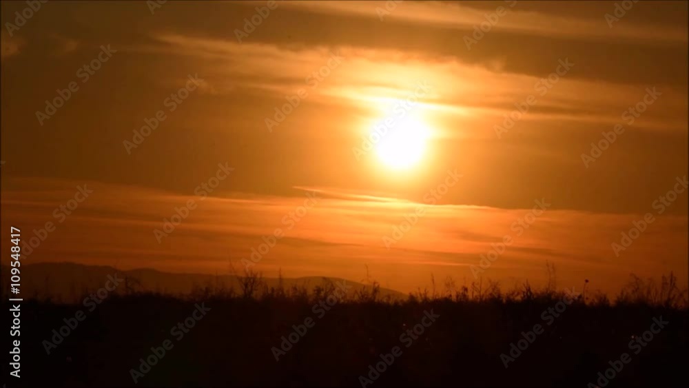 A man riding bicycle on the background of an orange sunset sky, slow motion. Cycling silhouette. Silhouette of man bicyclist against sunset.
A man riding bicycle on the background of an orange sunset sky, slow motion. Cycling silhouette. Silhouette of man bicyclist against sunset.
