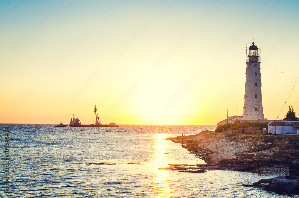 The lighthouse on sunset beach.
