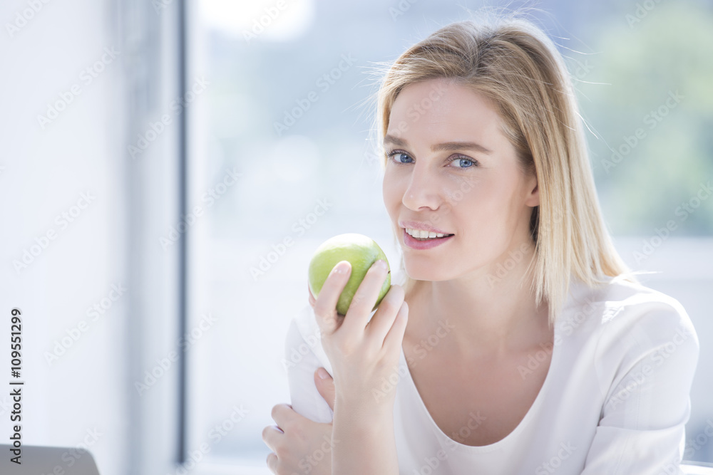 Business woman having healthy snack, eating apple Business woman having healthy snack, eating apple