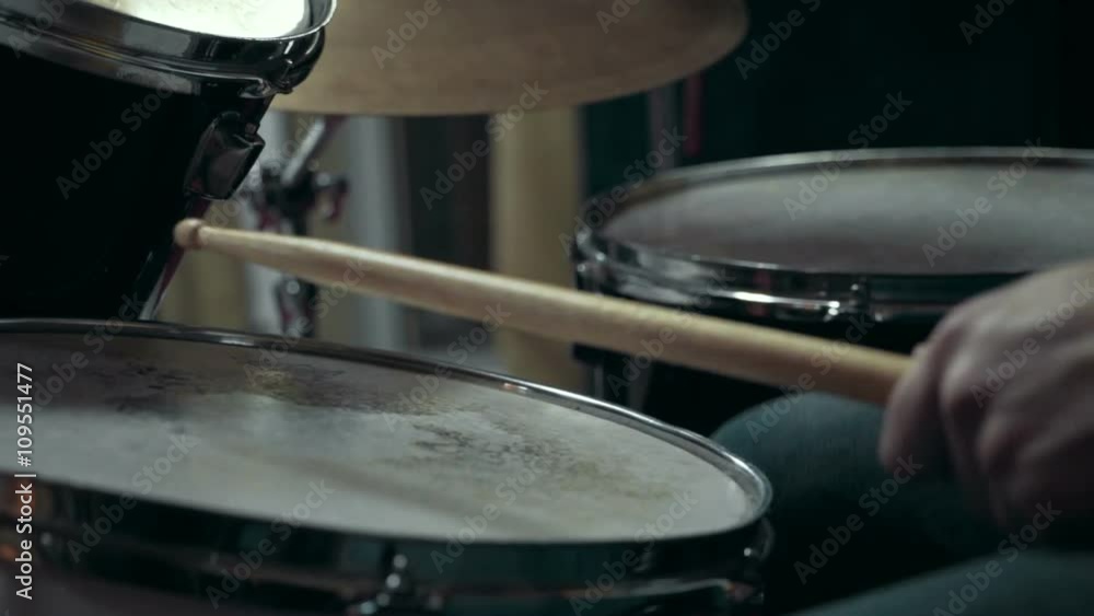 Musician playing drums at studio, close up Musician playing drums at studio, close up