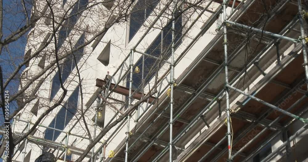 Construction on building exterior with scaffolding. Construction on building exterior with scaffolding.