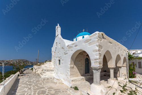 Amazing seascape with White chuch with blue roof in town of Parakia, Paros island, Cyclades, Greece photo