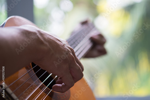 Acoustic guitar guitarist playing. Musical instrument with perfo photo