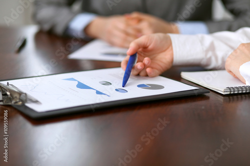 Close up of unknown business people at meeting discussing financial results