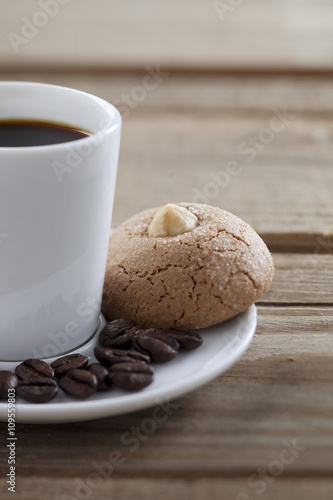 coffee cup with beans and cookie