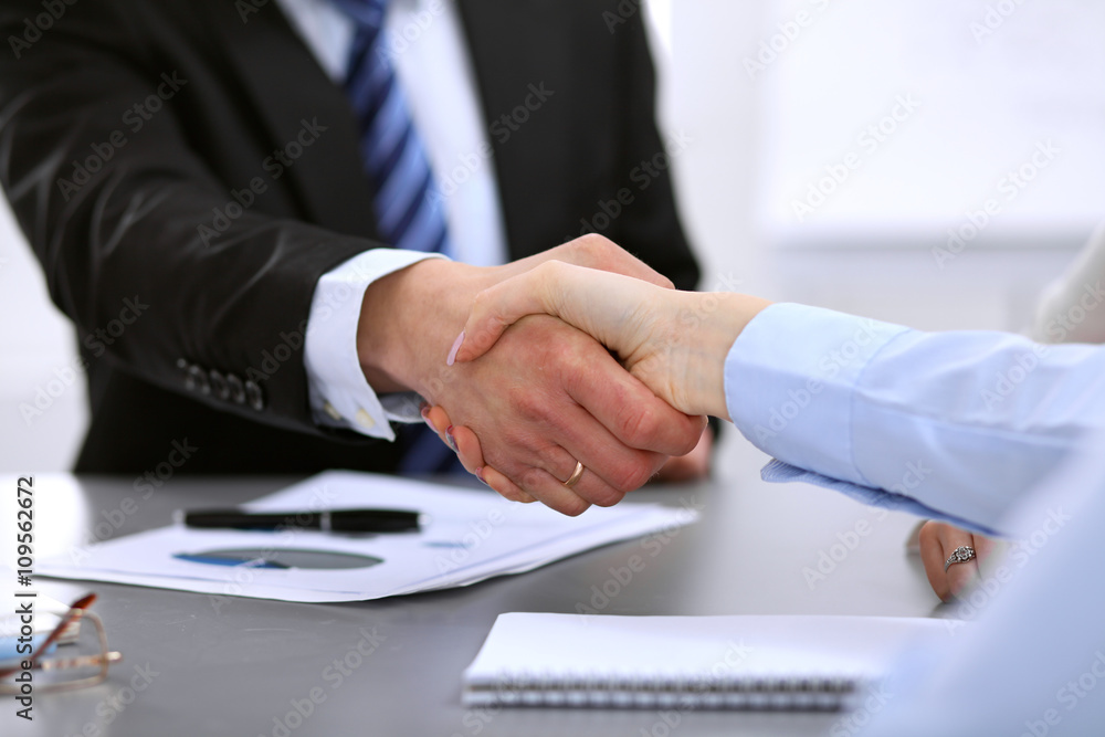 Business people shaking hands, finishing up a meeting Business people shaking hands, finishing up a meeting