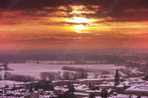 Sunset over snow covered rooftops, Cremona, Italy photo