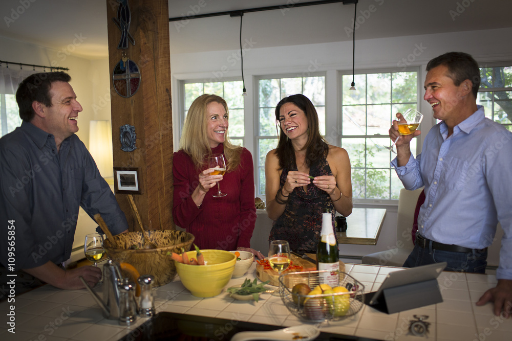 Two mature couples drinking wine at dinner party Two mature couples drinking wine at dinner party