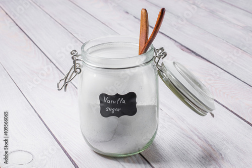Glass jar with vanilla sugar on a wooden table