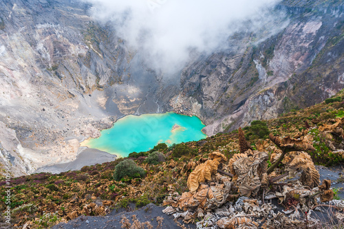 Main crater of Irazu Volcano with emerald lake  and mist. Central America. Costa Rica photo