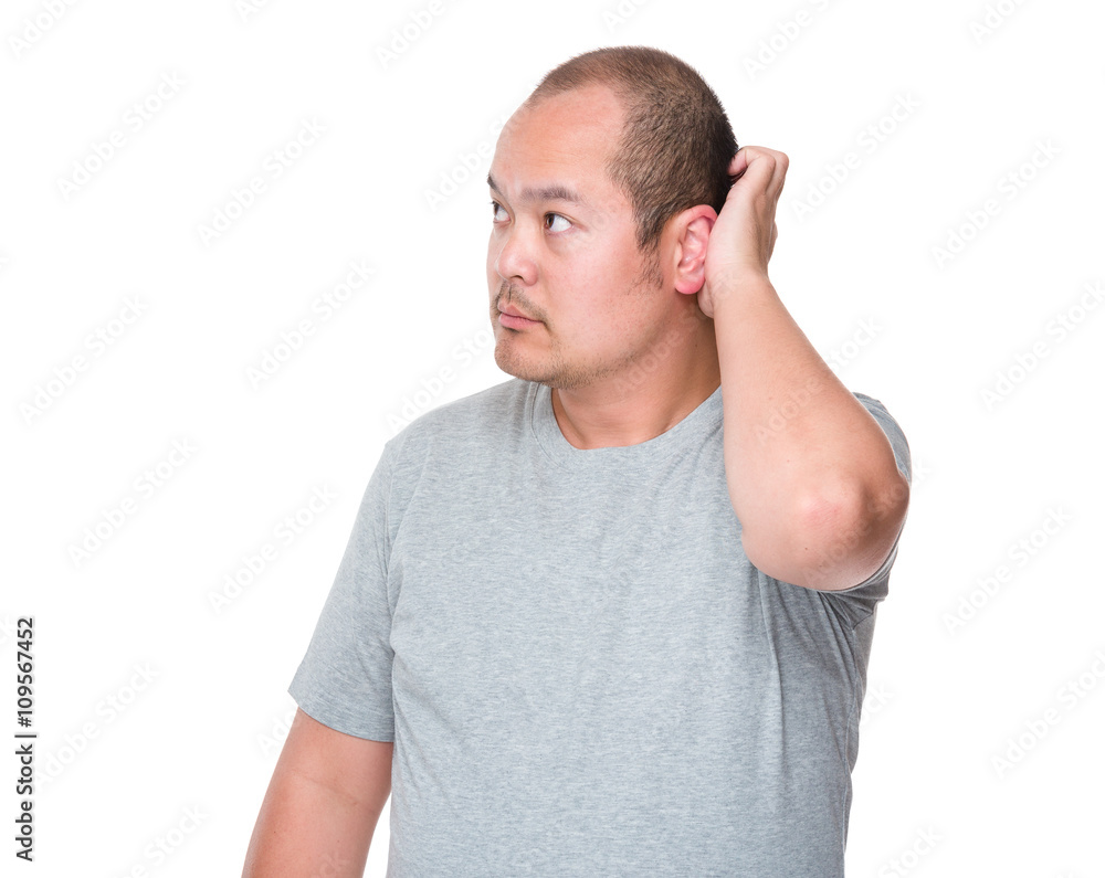 Confused mid adult man scratching his head Confused mid adult man scratching his head