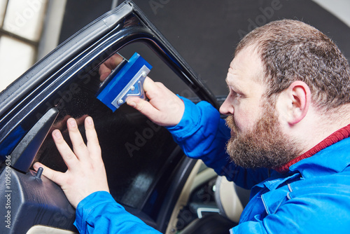 car tinting. Automobile mechanic technician applying foil 