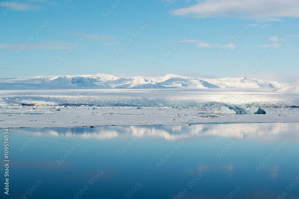 Blue ice in Jokulsarlon glacial lagoon with reflection, Vatnajokull glacier, Iceland