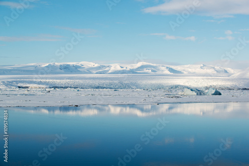 Blue ice in Jokulsarlon glacial lagoon with reflection, Vatnajokull glacier, Iceland © dash1502