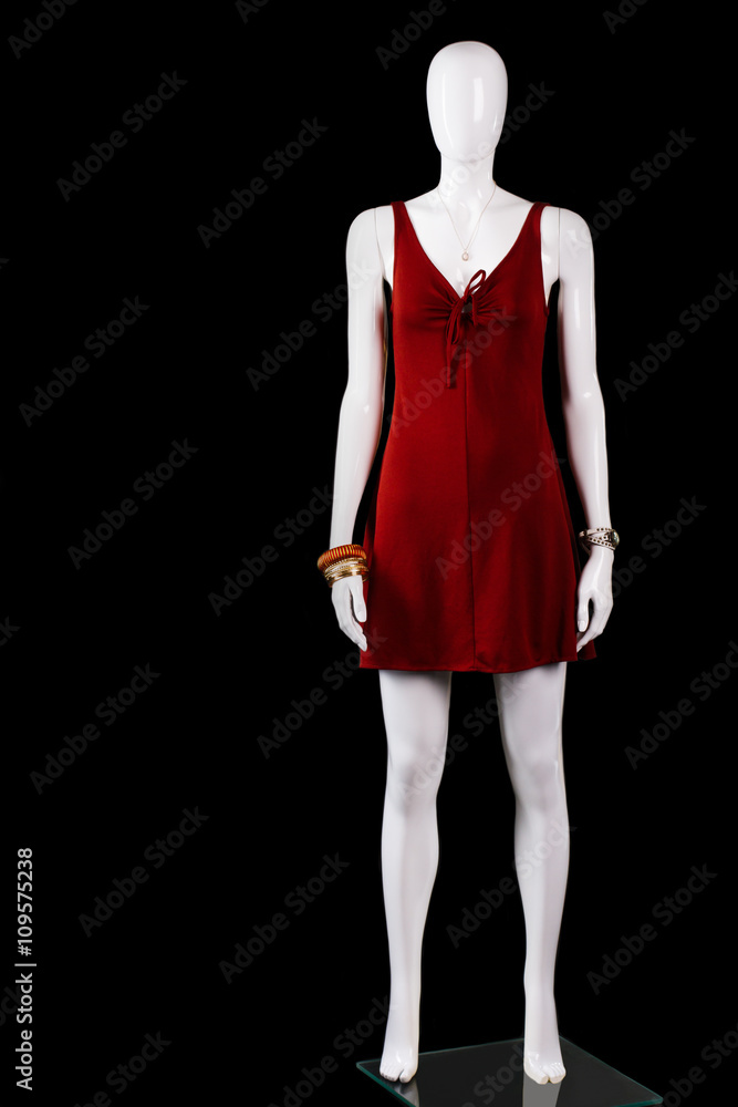 Red keyhole dress with accessories. Short red dress on mannequin. Woman's garment made of stretch. Fashionable dress in stock. Red keyhole dress with accessories. Short red dress on mannequin. Woman's garment made of stretch. Fashionable dress in stock.