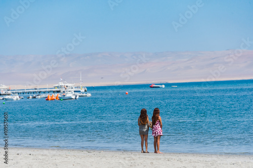 Sweer Lonely girl stand on the beach with dessert moutain view,