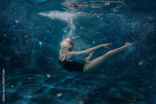 Woman dancing in the underwater.