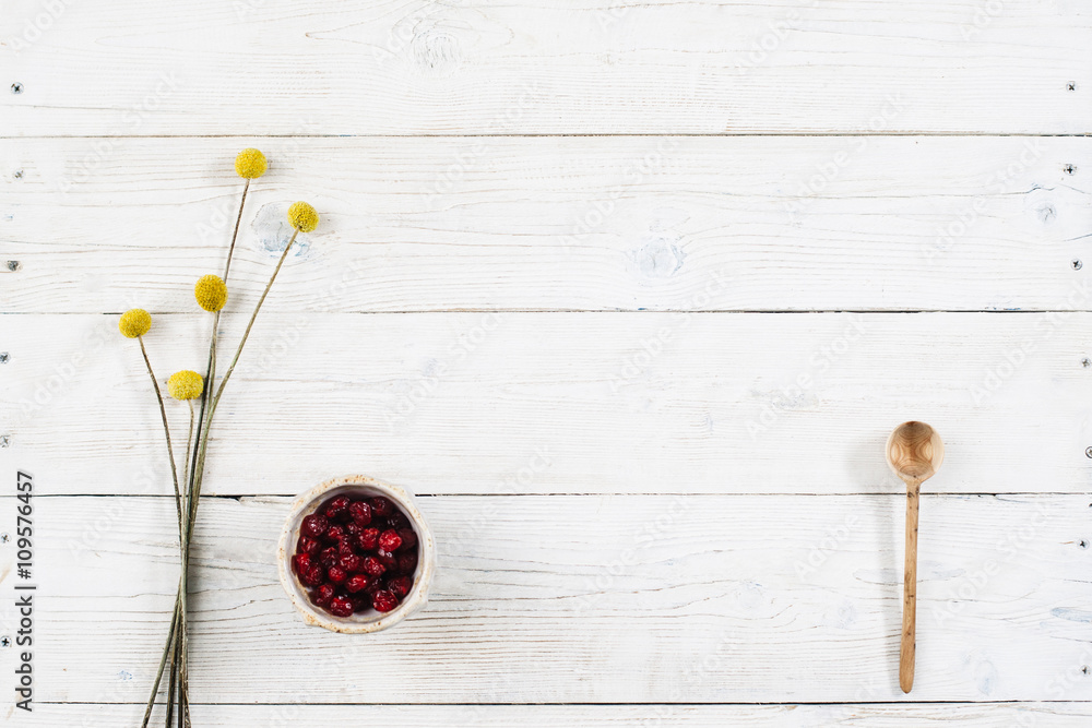 Fruit breakfast with free space on wooden table. Dried fruits and flowers with top view. Dietary food flat lay on white wooden background with copy space. Fruit breakfast with free space on wooden table. Dried fruits and flowers with top view. Dietary food flat lay on white wooden background with copy space.