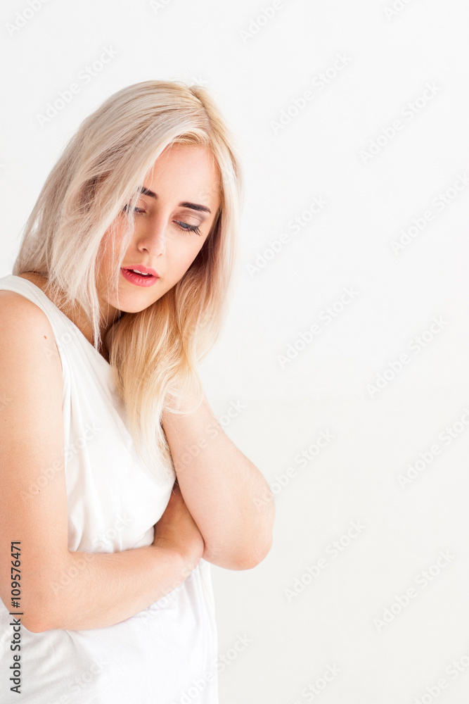 Woman with pain in neck on white background. Massage therapy of painful neck. Tired neck after long working hours. Woman relaxes the neck. Woman with pain in neck on white background. Massage therapy of painful neck. Tired neck after long working hours. Woman relaxes the neck.