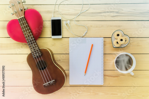 Blank note book and pencil with coffee,cookie, mobile phone and photo