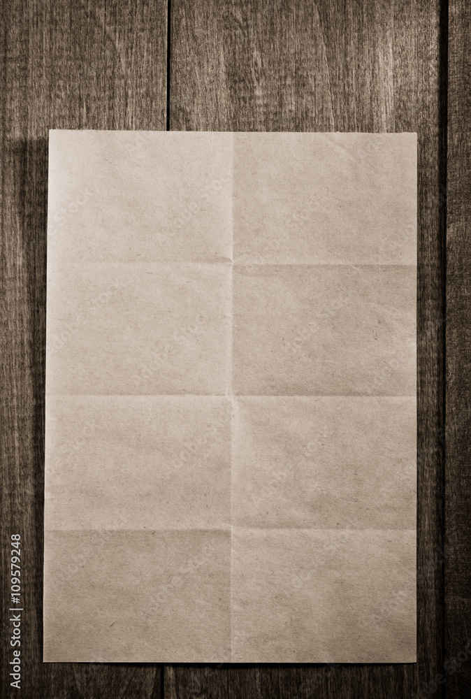 Fototapeta premium folded note paper on wood