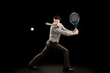 sport businessman plays tennis on black background