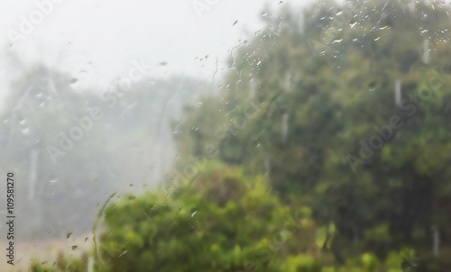 Abstract green nature background of rain water on mirror window