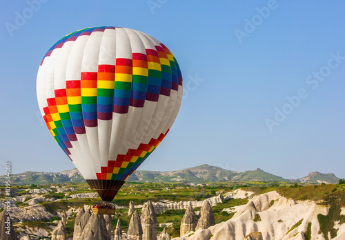 Multi-colored balloons in the sky of Cappadocia at sunrise, Turkey