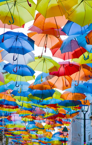 Street decorated with colored umbrellas.