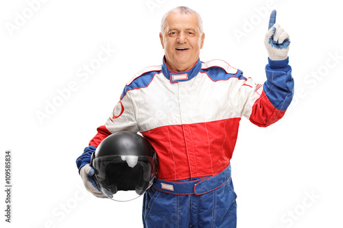 Car racer holding a helmet and pointing up