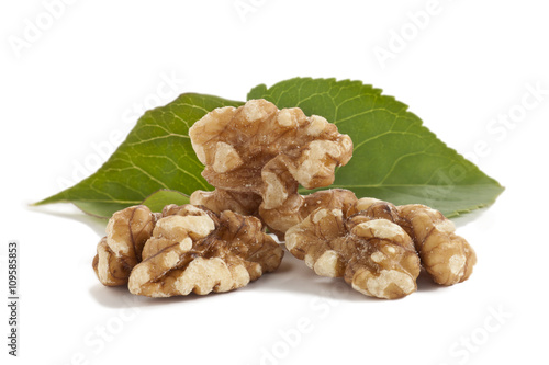 peeled walnuts with green leaves