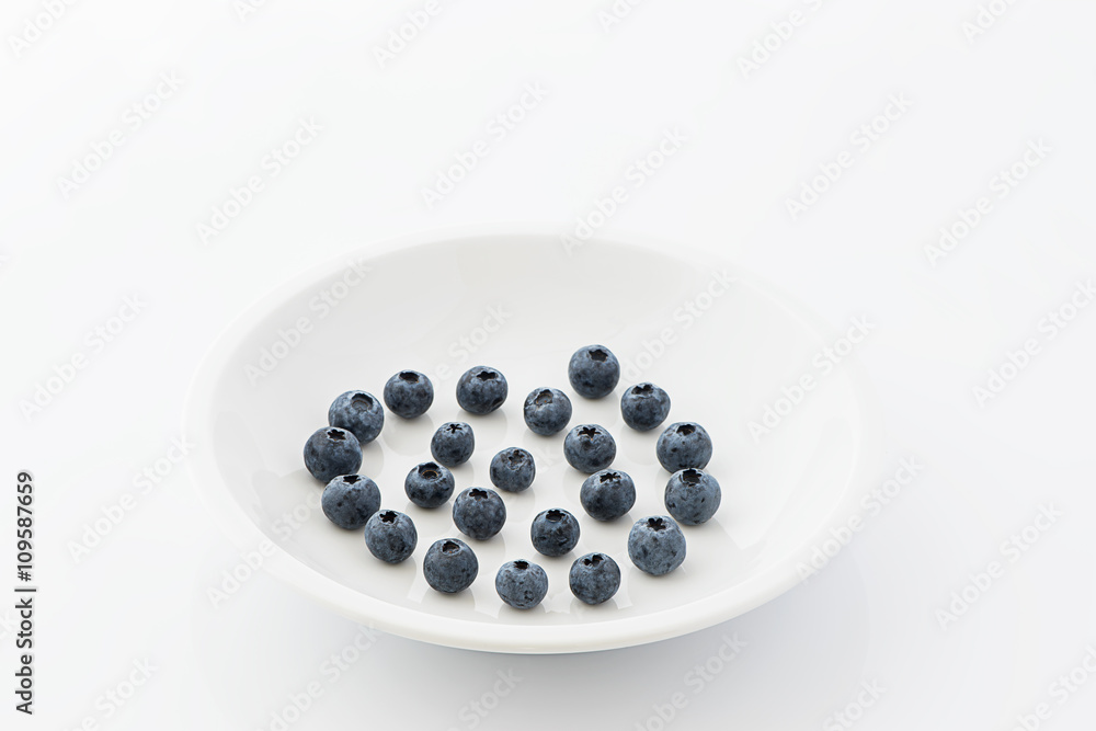 Fresh blueberries on a white plate