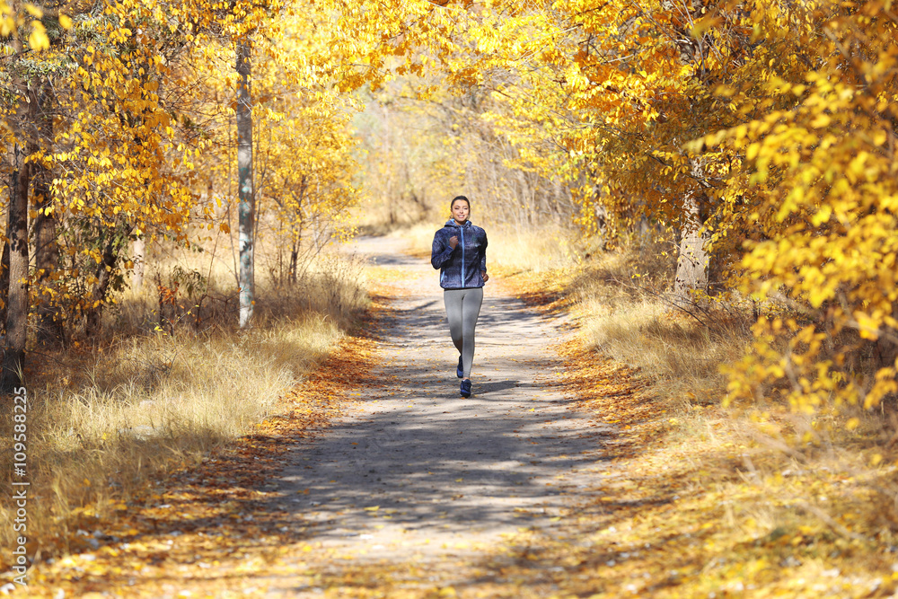 Young beautiful woman jogging in autumn park Young beautiful woman jogging in autumn park