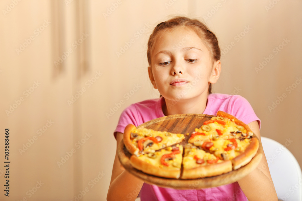 Little girl eating pizza at home Little girl eating pizza at home