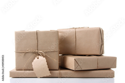 four small package tied with a rope with a tag on white isolated background