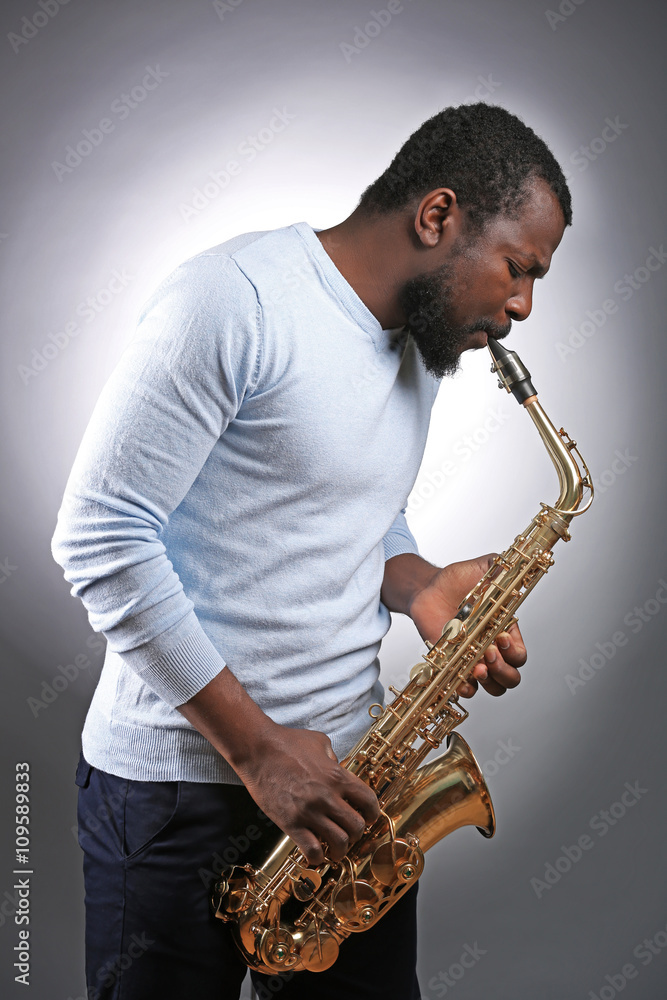 Naklejka premium African American jazz musician playing the saxophone