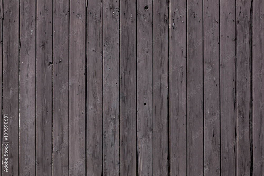 Fototapeta premium fence of vertical old brown purple planks or side of shed