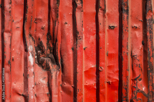 Red rusty container with blows