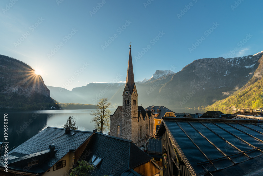 Hallstatt church and sunrise behind mountain