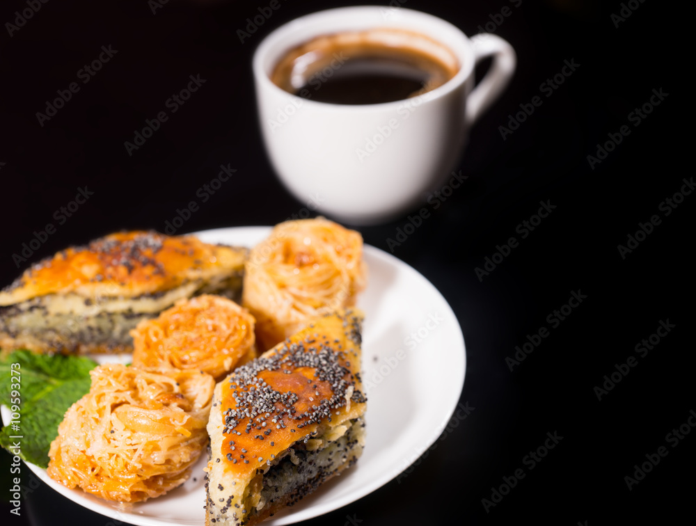 Plate of Sweet Pastries with Black Coffee on Black Plate of Sweet Pastries with Black Coffee on Black