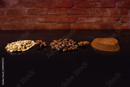 Roasted, Raw and Ground Coffee Beans on Black