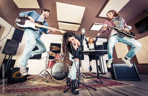 Obraz na plátne Rock band playing hard rock in the studio